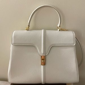 Minimalist white handbag with handle and strap, perf for office/date